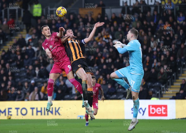 100224 - Hull City v Swansea City - Sky Bet Championship - Jerry Yates of Swansea and Jacob Greaves of Hull City leap for the ball