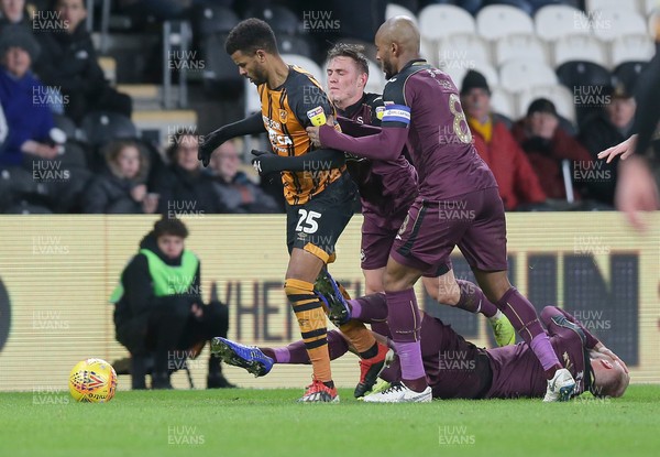 221218 - Hull City v Swansea City - Sky Bet Championship - Fraizer Campbell of Hull City being held by Leroy Fer of Swansea and Connor Roberts  of Swansea whilst Mike Van der Hoorn  of Swansea is floored
