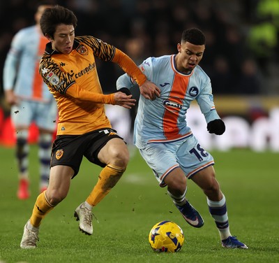 240126 - Hull City v Swansea City - Sky Bet Championship - Gustavo Nunes of Swansea and You Hirahawa of Hull AFC