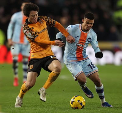 240126 - Hull City v Swansea City - Sky Bet Championship - Gustavo Nunes of Swansea and You Hirahawa of Hull AFC
