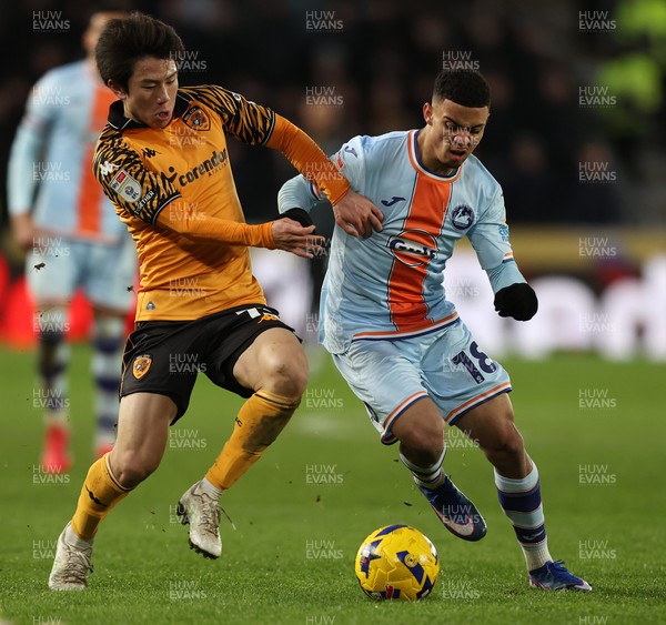 240126 - Hull City v Swansea City - Sky Bet Championship - Gustavo Nunes of Swansea and You Hirahawa of Hull AFC
