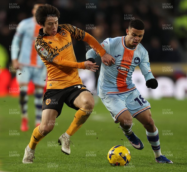 240126 - Hull City v Swansea City - Sky Bet Championship - Gustavo Nunes of Swansea and You Hirahawa of Hull AFC