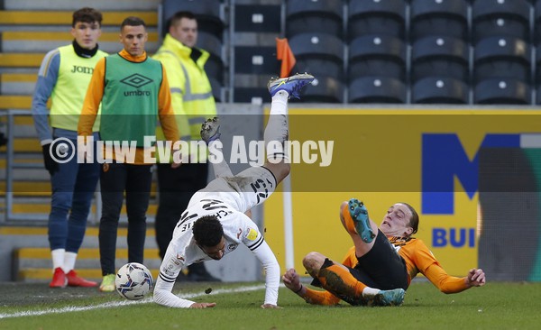 290122 - Hull City v Swansea City - Sky Bet Championship - Cyrus Christie of Swansea is sent flying by Tom Eaves of Hull City in 1st half