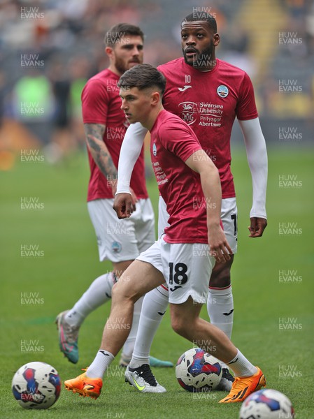 290423 - Hull City v Swansea City - Sky Bet Championship - Luke Cundle of Swansea and Olivier Ntcham of Swansea warm up before the match