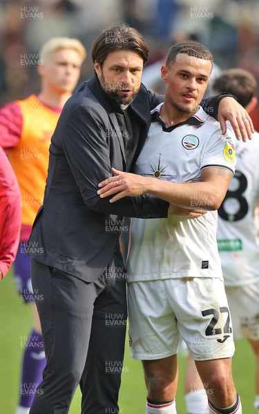 290423 - Hull City v Swansea City - Sky Bet Championship - Head Coach Russell Martin  of Swansea and Joel Latibeaudiere of Swansea at the end of the match