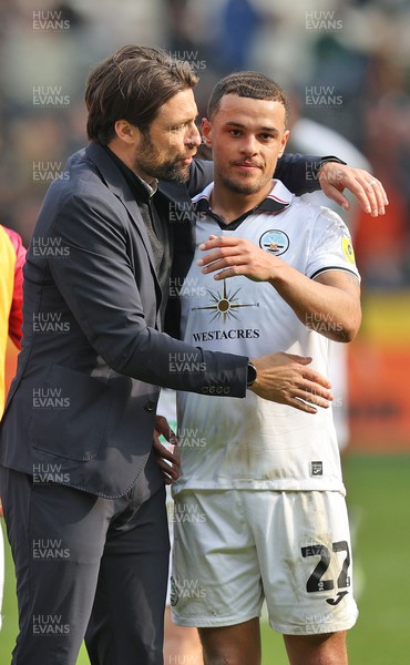 290423 - Hull City v Swansea City - Sky Bet Championship - Head Coach Russell Martin  of Swansea and Joel Latibeaudiere of Swansea at the end of the match