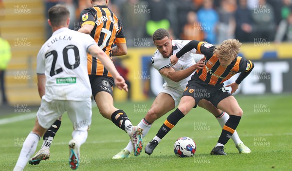 290423 - Hull City v Swansea City - Sky Bet Championship - Joel Latibeaudiere of Swansea tackles Harry Vaughan of Hull City 