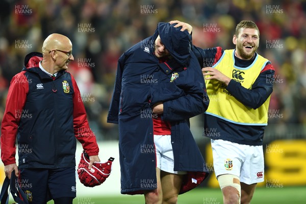 270617 - Hurricanes v British & Irish Lions - Robbie Henshaw of British & Irish Lions leaves the field after an injury as Finn Russell (right) raises a smile