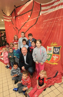 27.05.09 - Former Wales and British Lions star Ieuan Evans with children at the at the Sainsburys store on Colchester Avenue Cardiff after he signed the giant British and Irish Lions rugby shirt as it makes its way around the country. 