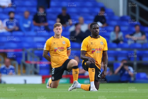 100821 - Ipswich Town v Newport County - Carabao Cup - Christopher Missilou and James Clarke of Newport County take the knee before kick off