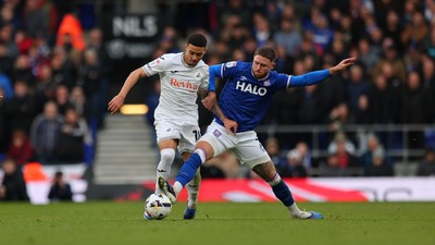 280226 - Ipswich Town v Swansea City - Sky Bet Championship - Ishe Samuels-Smith of Swansea City and Wes Burns of Ipswich Town 