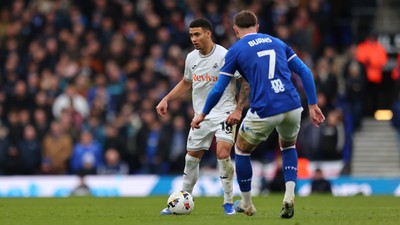 280226 - Ipswich Town v Swansea City - Sky Bet Championship - Gustavo Nunes of Swansea City and Wes Burns of Ipswich Town 