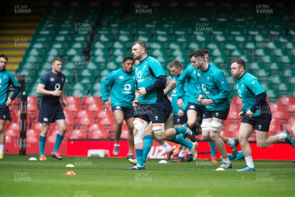 150319 - Ireland Rugby Captains Run, Principality Stadium - Ireland players warm up  on the pitch for a training session under an open roof at the Principality Stadium ahead of the Six Nations match against Wales tomorrow