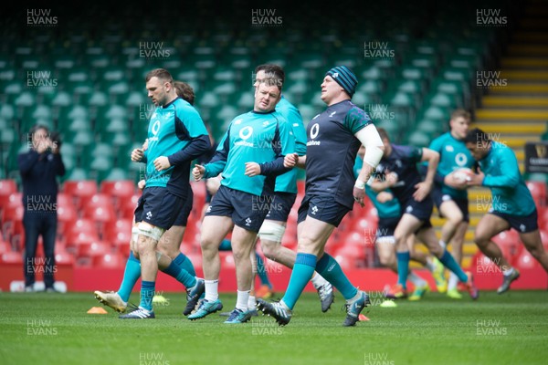 150319 - Ireland Rugby Captains Run, Principality Stadium - Ireland players warm up  on the pitch for a training session under an open roof at the Principality Stadium ahead of the Six Nations match against Wales tomorrow