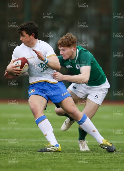 310318 - Ireland U18 v Italy U18, U18s Six Nations Festival, Ystrad Mynach - Matteo Moscardi of Italy is tackled by Karl Martin of Ireland