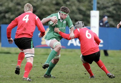 250206 Ireland U19 v Wales U19 -  Conor McInerney of Ireland tackled by Bradley Davis and Josh Turnbull of Wales 