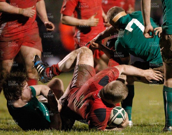 070214 -  Ireland v Wales  -U20 Nations -  Ethan Lewis of Wales tackled by Max Abbott and Jack O'Donoghue of Ireland (c) Huw Evans Agency