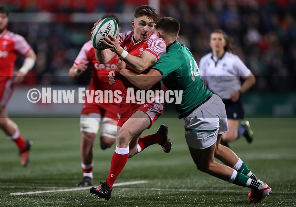 040222 - Ireland U20s v Wales U20s - U20s Six Nations Championship - Daniel Edwards of Wales is tackled by Chay Mullins of Ireland