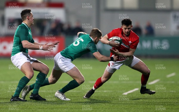 230218 - Ireland U20s v Wales U20s - Natwest 6 Nations - Tommy Rogers of Wales is tackled by Michael Silvester of Ireland