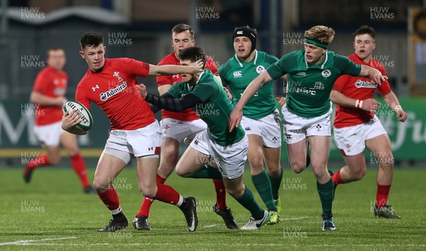 230218 - Ireland U20s v Wales U20s - Natwest 6 Nations - Tommy Rogers of Wales is tackled by Harry Byrne of Ireland