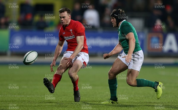230218 - Ireland U20s v Wales U20s - Natwest 6 Nations - Cai Evans of Wales chips the ball