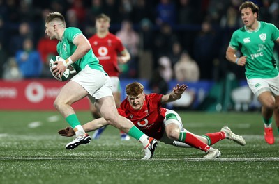 230224 - Ireland U20s v Wales U20s - U20s 6 Nations Championship - Finn Treacy of Ireland is tackled by Walker Price of Wales 