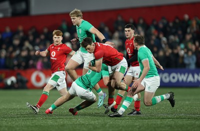 230224 - Ireland U20s v Wales U20s - U20s 6 Nations Championship - Louie Hennessey of Wales is tackled by Wilhelm de Klerk of Ireland 