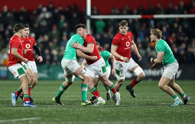 230224 - Ireland U20s v Wales U20s - U20s 6 Nations Championship - Harri Ackerman of Wales is tackled by Joe Hopes of Ireland 