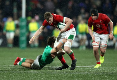 230224 - Ireland U20s v Wales U20s - U20s 6 Nations Championship - Osian Thomas of Wales is tackled by Wilhelm de Klerk of Ireland 