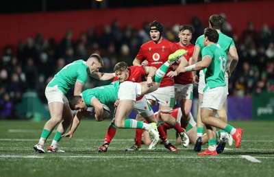 230224 - Ireland U20s v Wales U20s - U20s 6 Nations Championship - Sean Naughton of Ireland is tackled by Rhodri Lewis of Wales