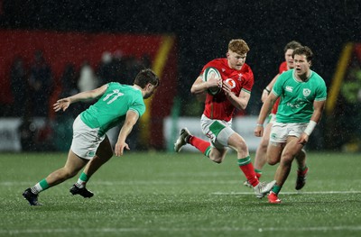 230224 - Ireland U20s v Wales U20s - U20s 6 Nations Championship - Walker Price of Wales is challenged by Hugo McLaughlin of Ireland 