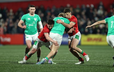 230224 - Ireland U20s v Wales U20s - U20s 6 Nations Championship - Harri Ackerman and Louie Hennessey of Wales tackle Hugh Gavin of Ireland 