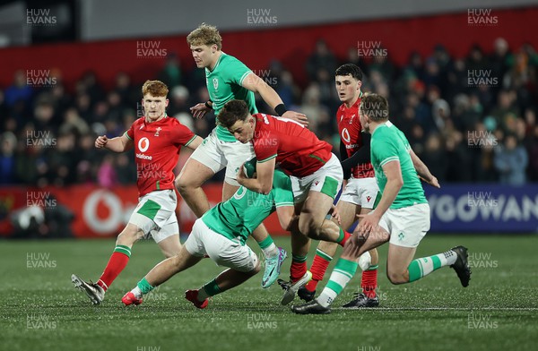 230224 - Ireland U20s v Wales U20s - U20s 6 Nations Championship - Louie Hennessey of Wales is tackled by Wilhelm de Klerk of Ireland 