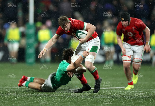 230224 - Ireland U20s v Wales U20s - U20s 6 Nations Championship - Osian Thomas of Wales is tackled by Wilhelm de Klerk of Ireland 