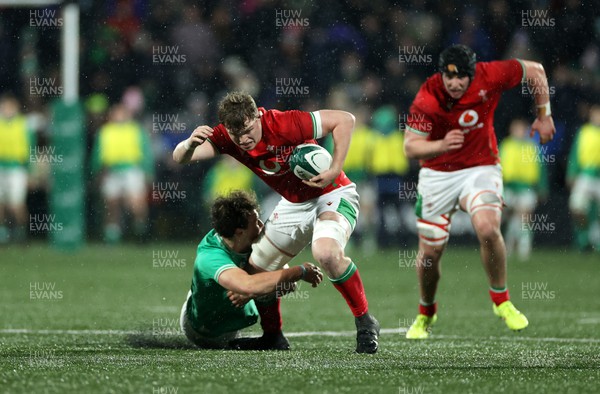 230224 - Ireland U20s v Wales U20s - U20s 6 Nations Championship - Osian Thomas of Wales is tackled by Wilhelm de Klerk of Ireland 