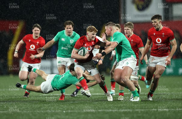 230224 - Ireland U20s v Wales U20s - U20s 6 Nations Championship - Walker Price of Wales is tackled by Hugo McLaughlin of Ireland 