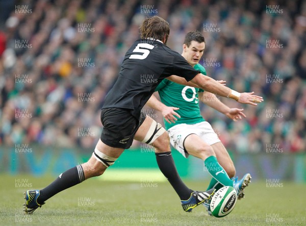 241113 - Guinness Series - Ireland v New Zealand  Jonny Sexton of Ireland kicks past Sam Whitelock of New Zealand(c) Huw Evans Agency