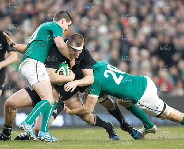 241113 - Guinness Series - Ireland v New Zealand  Brodie Retallick of New Zealand is tackled by Jonny Sexton and Kevin McLaughlin of Ireland(c) Huw Evans Agency