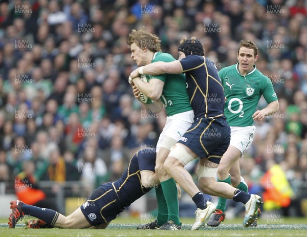 100312 - Ireland v Scotland - RBS 6 Nations -  Andrew Trimble of Ireland tackled by Ross Rennie of Scotland