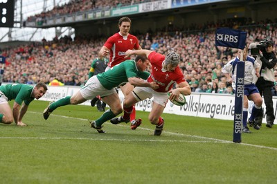 05.02.12  Ireland  v Wales .Wales' Jonathan Davies scores try despite tackle by Gordon D'Arcy of Ireland..