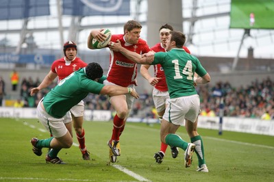 05.02.12  Ireland  v Wales .Wales' Rhys Priestland is tackled by Mike Ross of Ireland and Tommy Bowe..