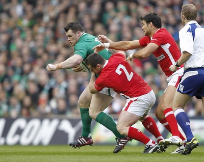 05.02.12 - Ireland v Wales - RBS Six Nations.Ireland's Cian Healy is tackled by Wales' Huw Bennett and Mike Phillips.