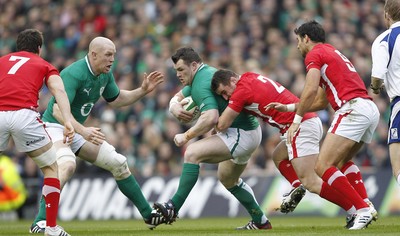 05.02.12 - Ireland v Wales - RBS Six Nations.Ireland's Cian Healy is tackled by Wales' Huw Bennett and Mike Phillips.