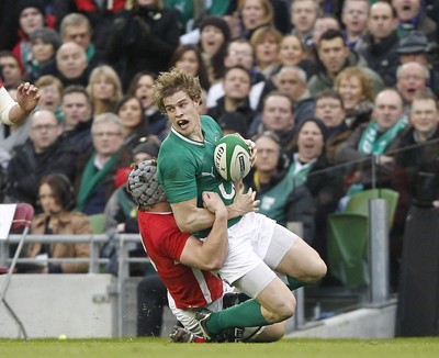 05.02.12 - Ireland v Wales - RBS Six Nations.Ireland's Andrew Trimble is tackled by Wales' Jonathan Davies.