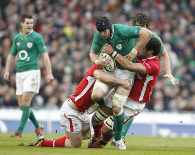 05.02.12 - Ireland v Wales - RBS Six Nations.Ireland's Stephen Ferris is tackled by Wales' Rhys Priestland and Toby Faletau.