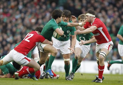 05.02.12 - Ireland v Wales - RBS Six Nations.Ireland's Conor Murray hands off Wales' Ryan Jones as Jamie Roberts makes the tackle.