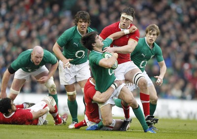 05.02.12 - Ireland v Wales - RBS Six Nations.Ireland's Conor Murray hands off Wales' Ryan Jones as Jamie Roberts makes the tackle.