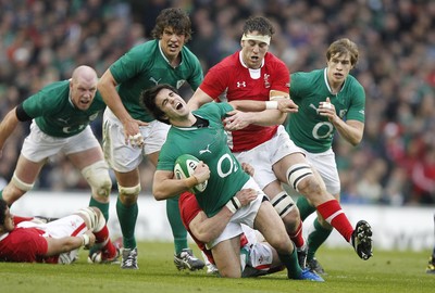 05.02.12 - Ireland v Wales - RBS Six Nations.Ireland's Conor Murray hands off Wales' Ryan Jones as Jamie Roberts makes the tackle.