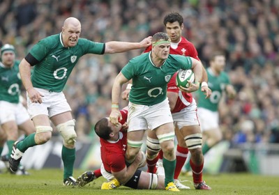 05.02.12 - Ireland v Wales - RBS Six Nations.Ireland's Jamie Heslip breaks through the tackle from Wales' Ian Evans.