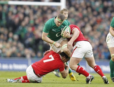 05.02.12 - Ireland v Wales - RBS Six Nations.Ireland's Jamie Heaslip is tackled by Wales' Sam Warburton and Huw Bennett.